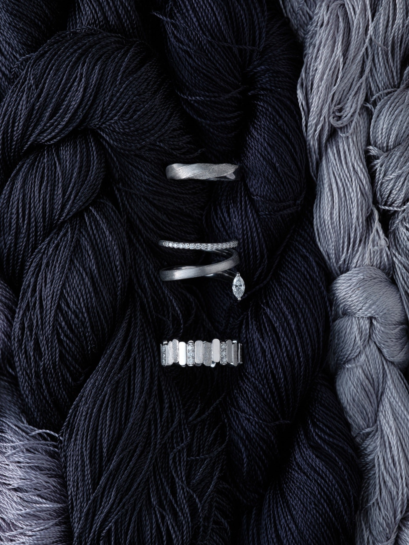 ARCELF — hands, crossed, against black